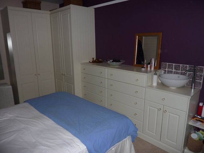Purple walls and white furniture bedroom design
